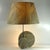 A unique, large, and striking table lamp crafted from natural stone—granite with a slight mica content. Two stone circles...