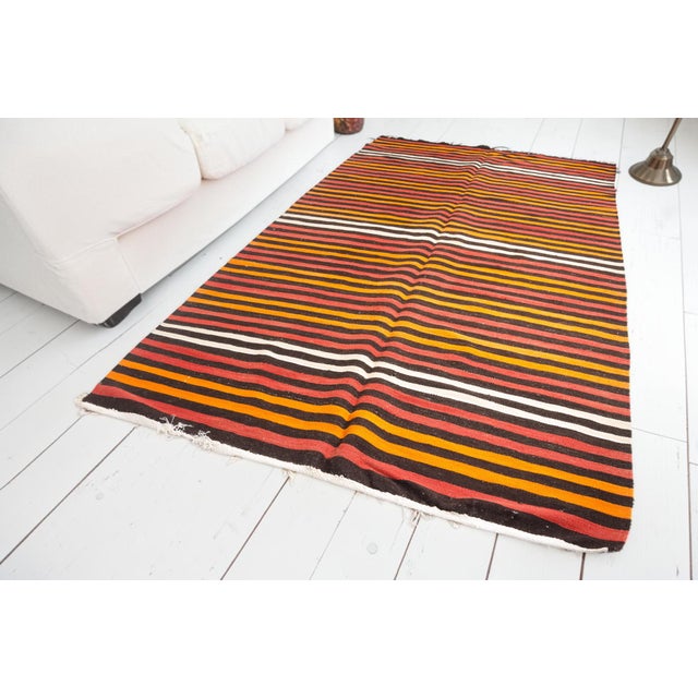 This is a vintage Turkish Oushak rug from the Mid 20th Century. The piece was hand-knotted.