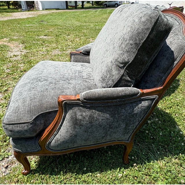 This is a classic pair of French Bergere newly upholstered club chairs. These club chairs have a dark walnut frame in the...