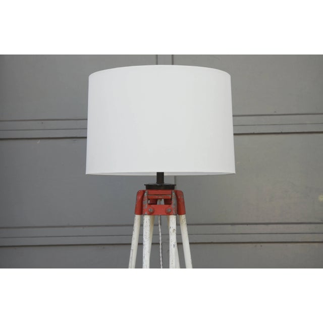 Tall industrial surveyor tripod floor lamp. Dimensions listed are for the lamp and shade installed. Measures: Shade itself...