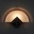 A sophisticated lighting element with a refined geometric design. This rare and valuable wall lamp represents a perfect...