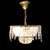 This antique French chandelier, dating to approximately 1920, features a brass frame adorned with multiple tiers of cut...