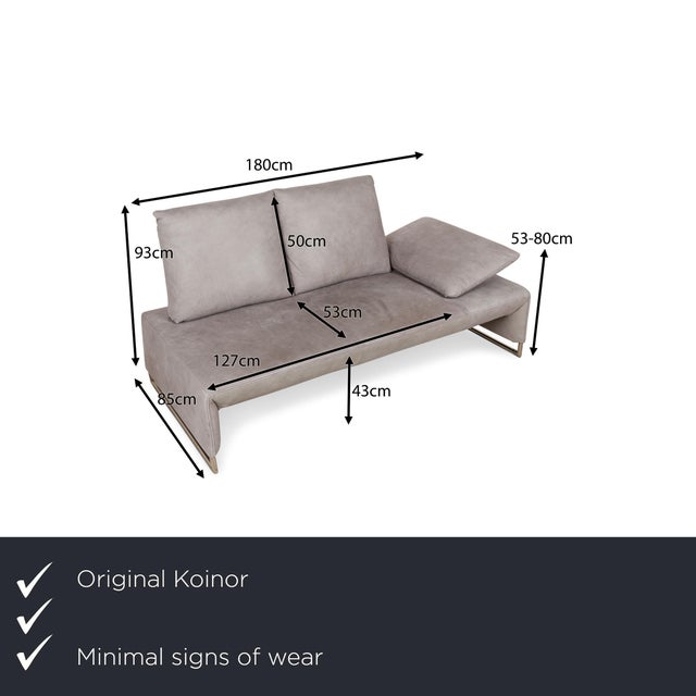 The Ramon sofa from Koinor is covered in gray genuine leather and stands on narrow metal runners. The asymmetrical design...