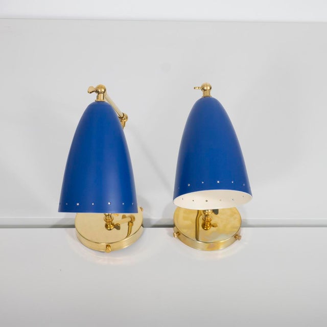 Pair of mid-century style articulated sconces with blue painted bullet shades. Depth and height measured as shown. Depth...