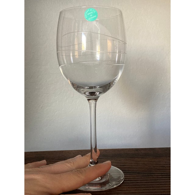 This listing features a brand new, unused set of two Tiffany & Co. crystal wine glasses, presented in the original Tiffany...
