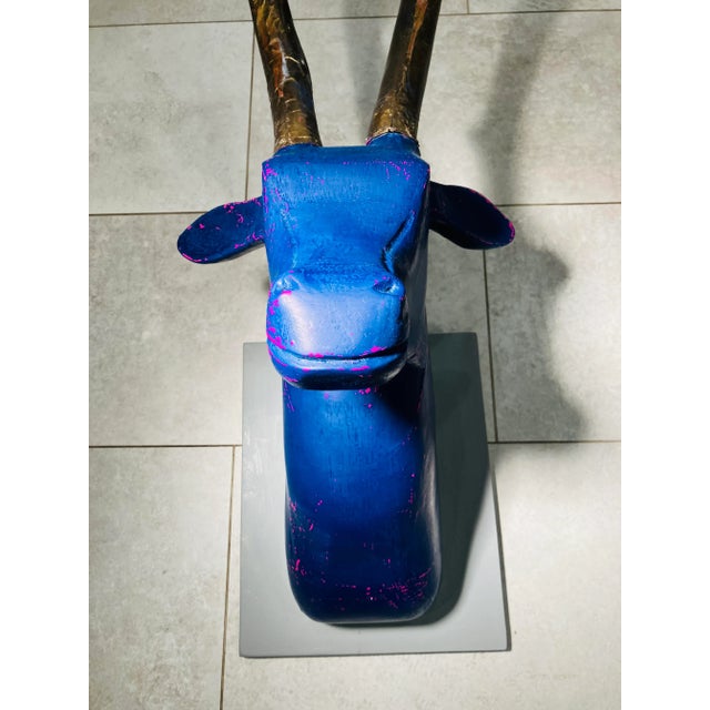 This hand carved wooden deer was found in southern Maine. The under coat of magenta is exposed in places on the dark lapis...