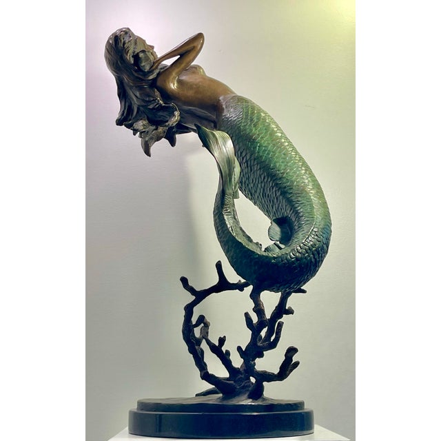This large beautiful Mermaid sculpture is cast in bronze. The piece exudes a sense of serene contemplation, delicately...