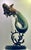 This large beautiful Mermaid sculpture is cast in bronze. The piece exudes a sense of serene contemplation, delicately...