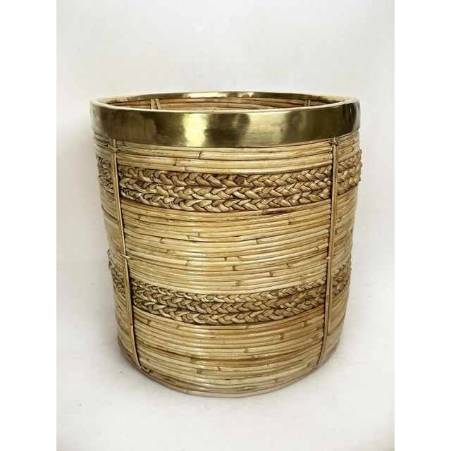 Woven rush basket with brass band, France, French Riviera style, 1960s. A beautiful cylindrical decorative basket made of...