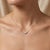 Enchant your style with this luminous two-stone pendant necklace, featuring two glowing, mystical heart-shaped gemstones...