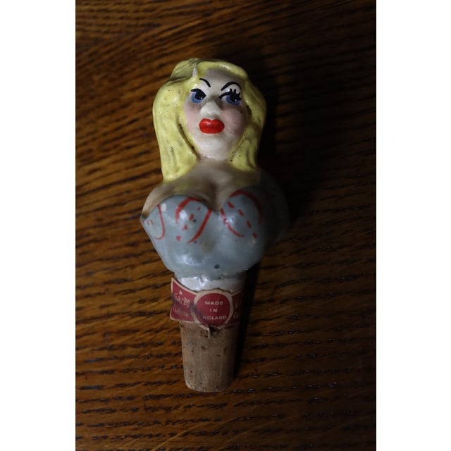 Rare antique English ceramic bottle stopper depicting a whimsical hand-painted blonde woman in a strapless blue bodice...