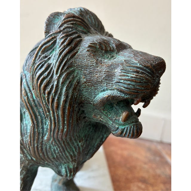 This bronze lion's majestic and commanding posture has a lifelike and powerful presence. I love the defensive guardian...