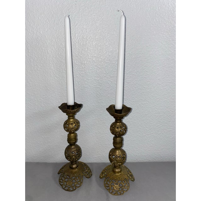 Set of two matching brass candlesticks. Vintage, filigree/pierced design. The base and body are screwed together with a...