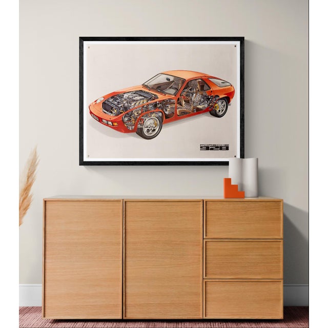 An original vintage cutaway poster featuring the iconic Porsche 928 in red. The detailed technical illustration showcases...