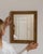 Carved giltwood mirror in Antique Gold. Its antique gold finish sets off rectangular molded frame, warm aged gilt, a...