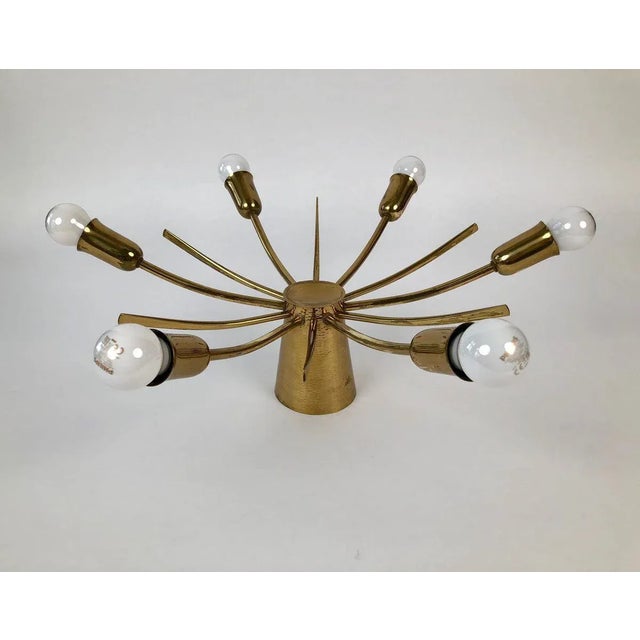 This sun ceiling lamp made in solid brass with a hand hammered cone features 6-light bulbs (40 Watt). Made in France,...
