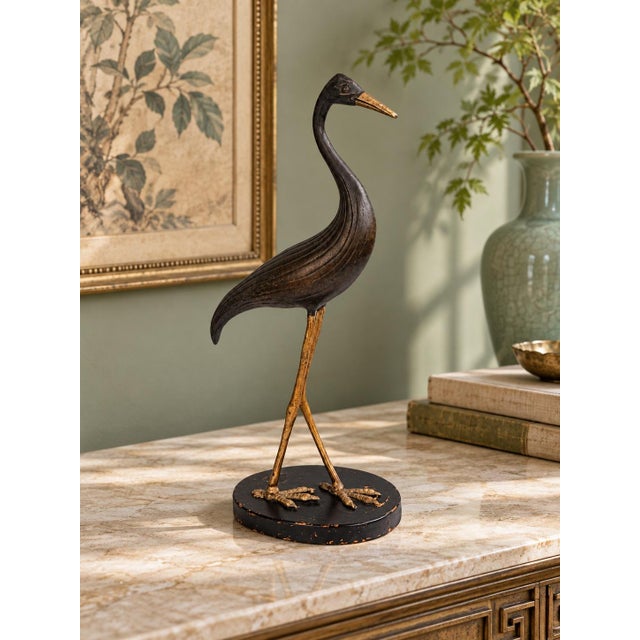 Elegant vintage heron sculpture featuring a graceful curved neck, elongated legs, and flowing incised feather details. The...