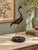 Elegant vintage heron sculpture featuring a graceful curved neck, elongated legs, and flowing incised feather details. The...
