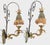 A dramatic pair of mid-century Italian wall sconces in the Hollywood Regency idiom — scrolled, serpentine arms in aged...