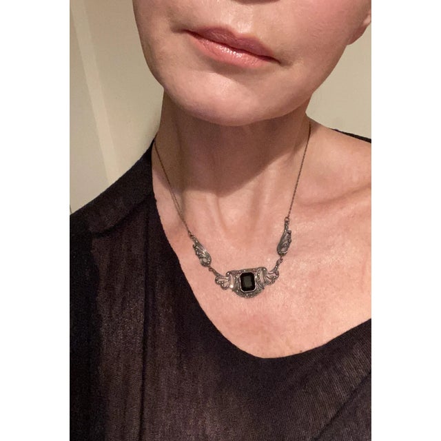 This is part of Chairish’s Fine Jewelry assortment. A sterling silver and black onyx necklace, in the Art Nouveau style,...