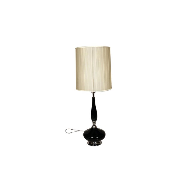 This is a stunning and very sought-after mid century, Hollywood Regency, ceramic table lamp with an elongated neck, over...