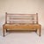 A striking mid-century oak hall bench with clean architectural lines and a handwoven rush seat, likely Dutch or...