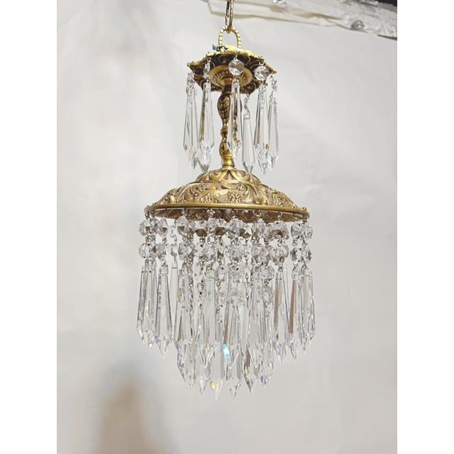 This is a decorative brass frame rim chandelier with layered octagon bead chains and 30% leaded U-drop crystals. It has 1...
