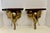 Pair vintage brass elephant head wall brackets featuring polished gold-tone faces and protruding tusks mounted into dark...