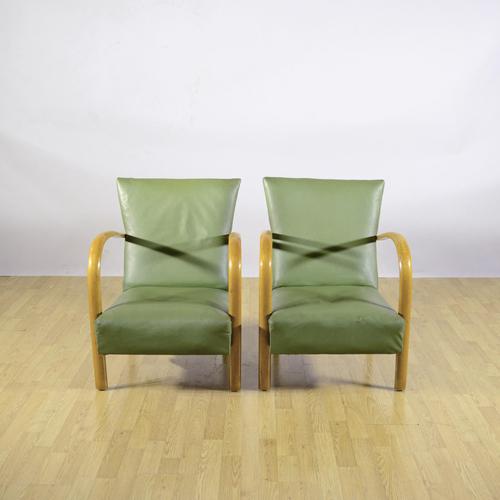 This charming pair of armchairs reflects the late art deco taste of the 1950s, a period in which structural solidity met...