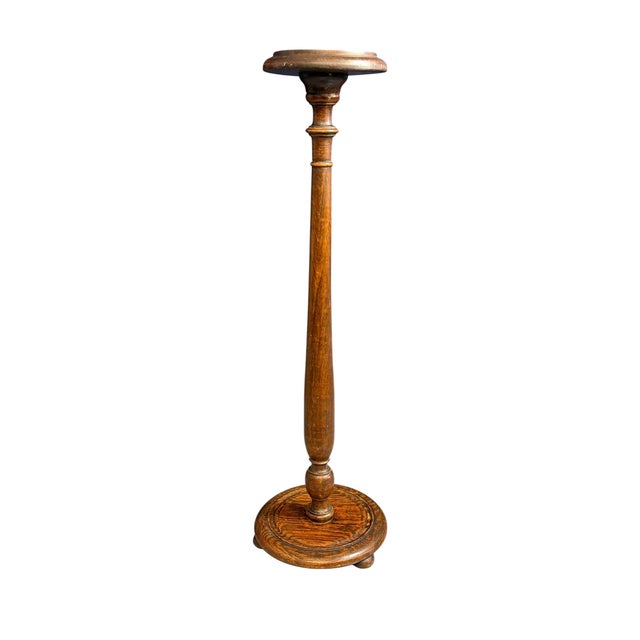 This antique turned wood pedestal stand, also known as a jardinere, dates to approximately 1930. It features a classic...
