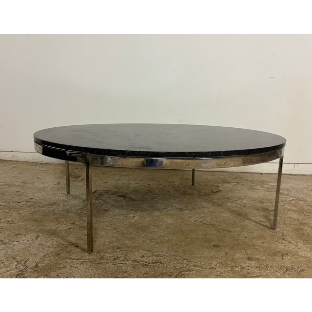 This is a round granite coffee table with chrome legs and base. This is designed by Nicos Zographos, the greek born...