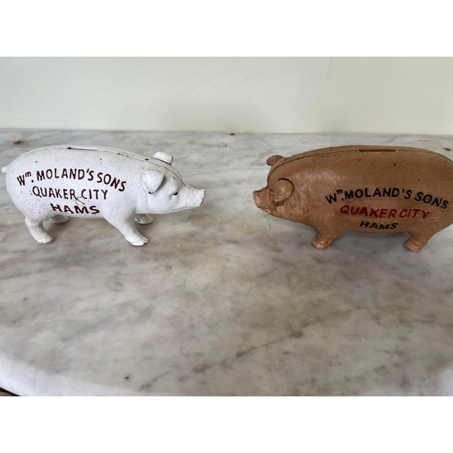 Pair of cast iron Wm Moland’s sons, Quaker City branded piggy banks A rare and amusing pair of cast iron Wm Moland’s sons,...