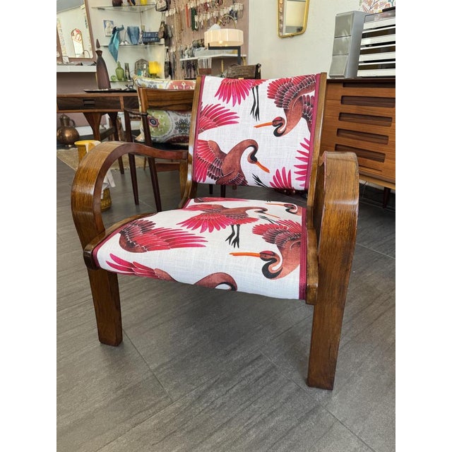 Armchair from the 1930s, newly upholstered in a colorful fabric with cranes Woodwork in refurbished condition
