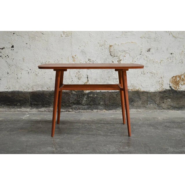 Great modern teak coffee table with shelf. Wonderfully clean and simple lines very nice design and craftsmanship quality...