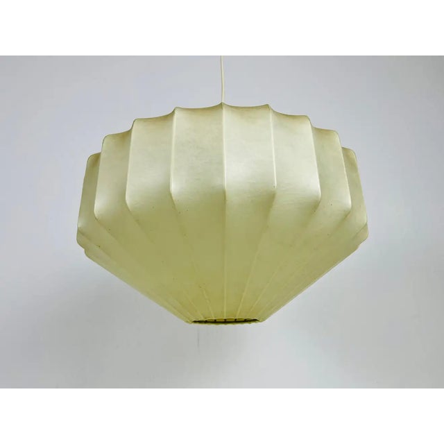 A losange cocoon pendant lamp made in Italy in the 1960s. The hanging lamp has a design similar to the lightings made by...
