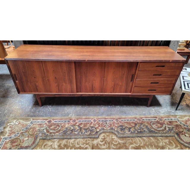Extra wide Danish Modern rosewood credenza. Made in Denmark, Circa. 1960's. Very nice original finish with nice glow from...
