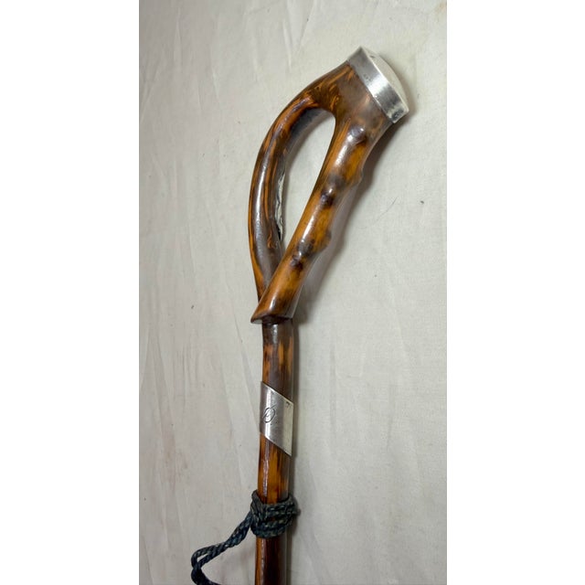 This antique 19th century handmade sterling silver and wooden cane is a unique and stylish accessory. The intricate...