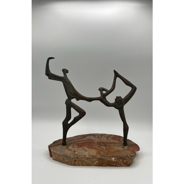 Classic mid century brutalist sculpture of ballet dancers in motion casting great shadow throuhout the day. Piece captures...