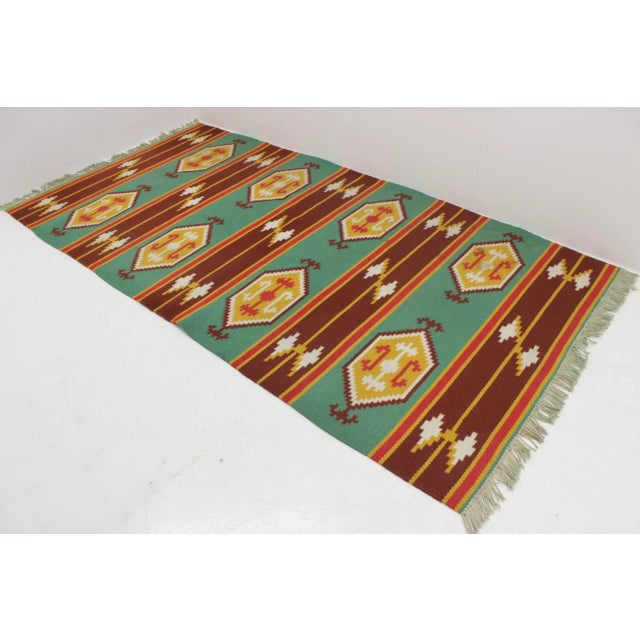 This vintage double-sided rug was produced in Czechoslovakia in the 1970s.