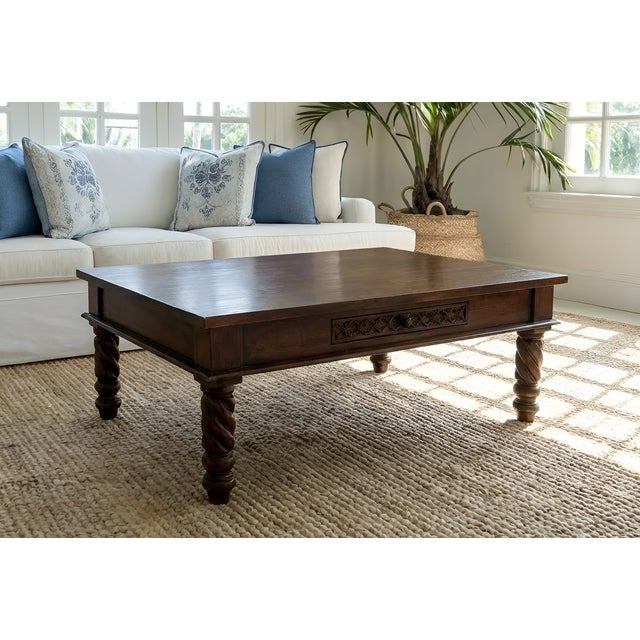 Vintage solid wood coffee table featuring elegant barley twist legs and a hand-carved drawer apron. The rich walnut finish...