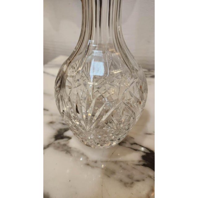 Vintage clear glass decanter with spherical topper. A decanter is a vessel that is used to hold the decantation of a...