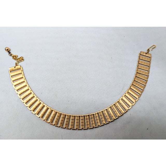 1970s goldtone textured collar necklace with hook clasp. Marked "NAPIER" on the hook. Measures: 4 1/2 inches long by 4 1/2...