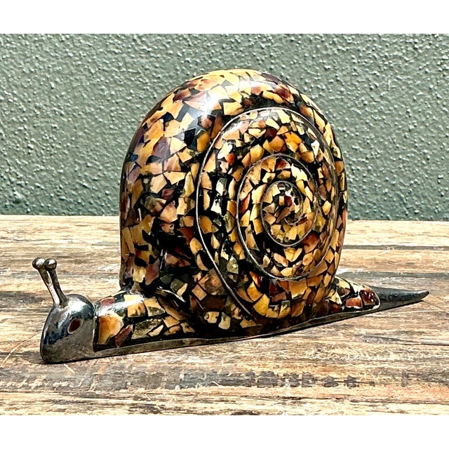 This charming vintage snail figurine is a masterful example of mid-century artisanal craftsmanship. Featuring a...