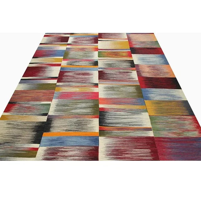This remarkable Scandinavian style kilim rug features a dramatic pop of electrifying colors in a playfully rich design....