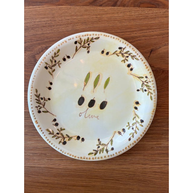 This is a set of 9 melamine salad plates. The design is olive branches on a mottled creamy yellow background. The design...