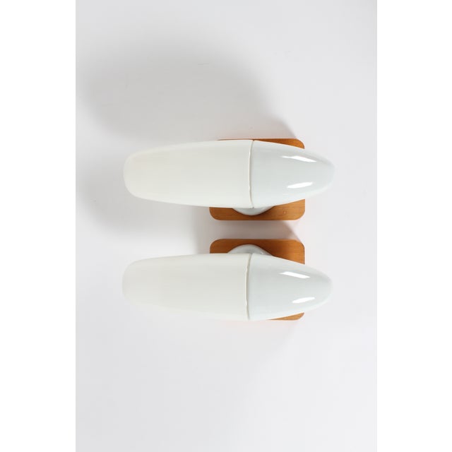 Set of two original vintage wall sconces by German designer Wilhelm Wagenfeld. They were manufactured by Lindner...
