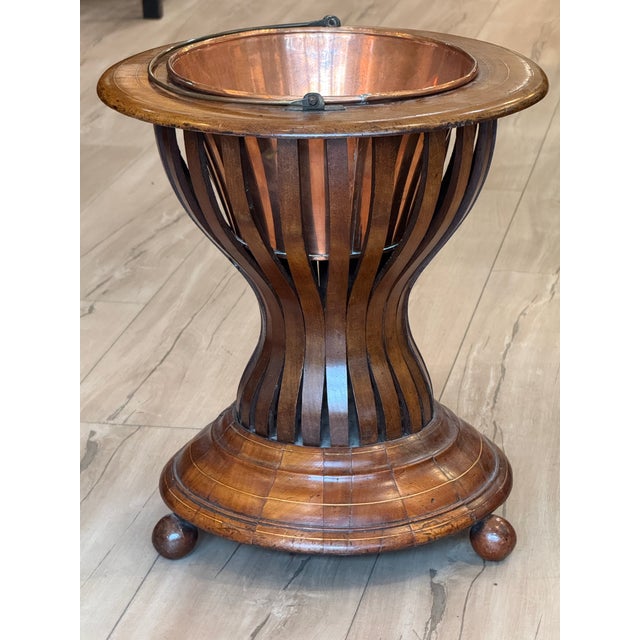 A beautifully proportioned mahogany peat bucket of classical hourglass form, the staved body with boxwood stringing rising...