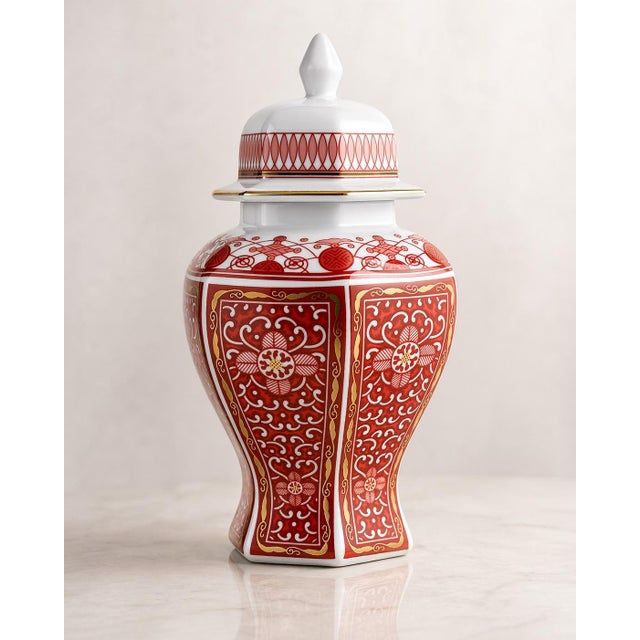 A richly detailed Imperial Brocade porcelain urn showcasing intricate red, white, and gold decoration inspired by 19th-...