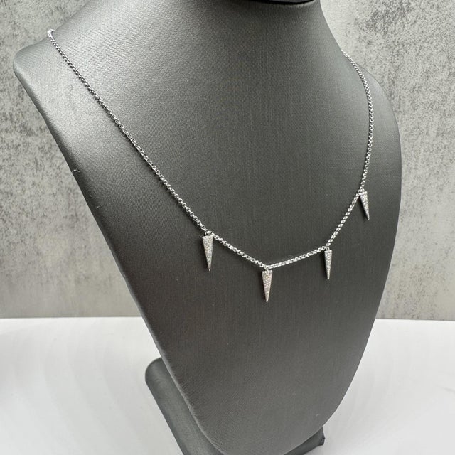 This elegant diamond dangle charm necklace in 18kt white gold features 0.15 carats total weight of natural GH VS/SI round...