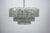 The chandelier features three graduated tiers of clear Murano glass elements, each with a heavily textured, irregular...
